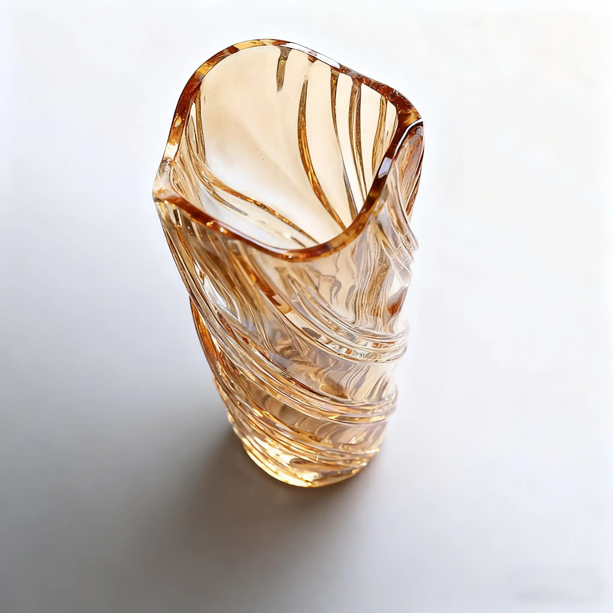 Amber glass vase with twisted patterns, showcasing elegant craftsmanship.